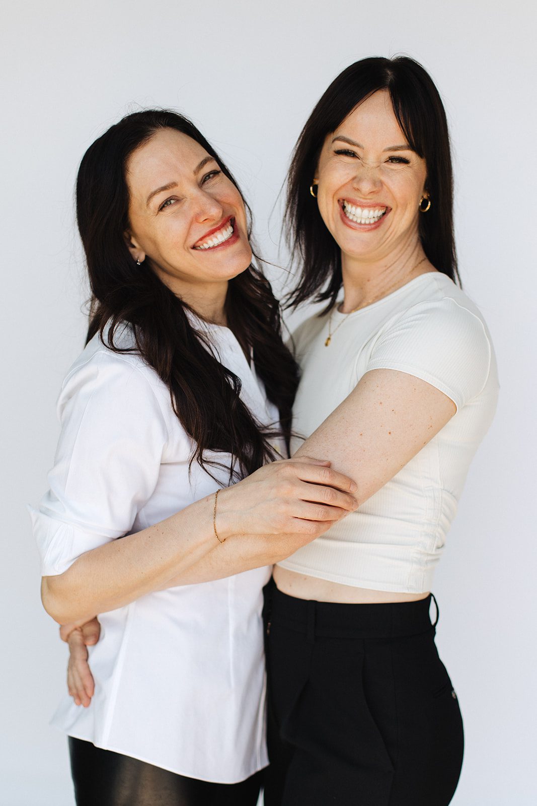 Onyx Beauty Lab team embrace in a hug.
