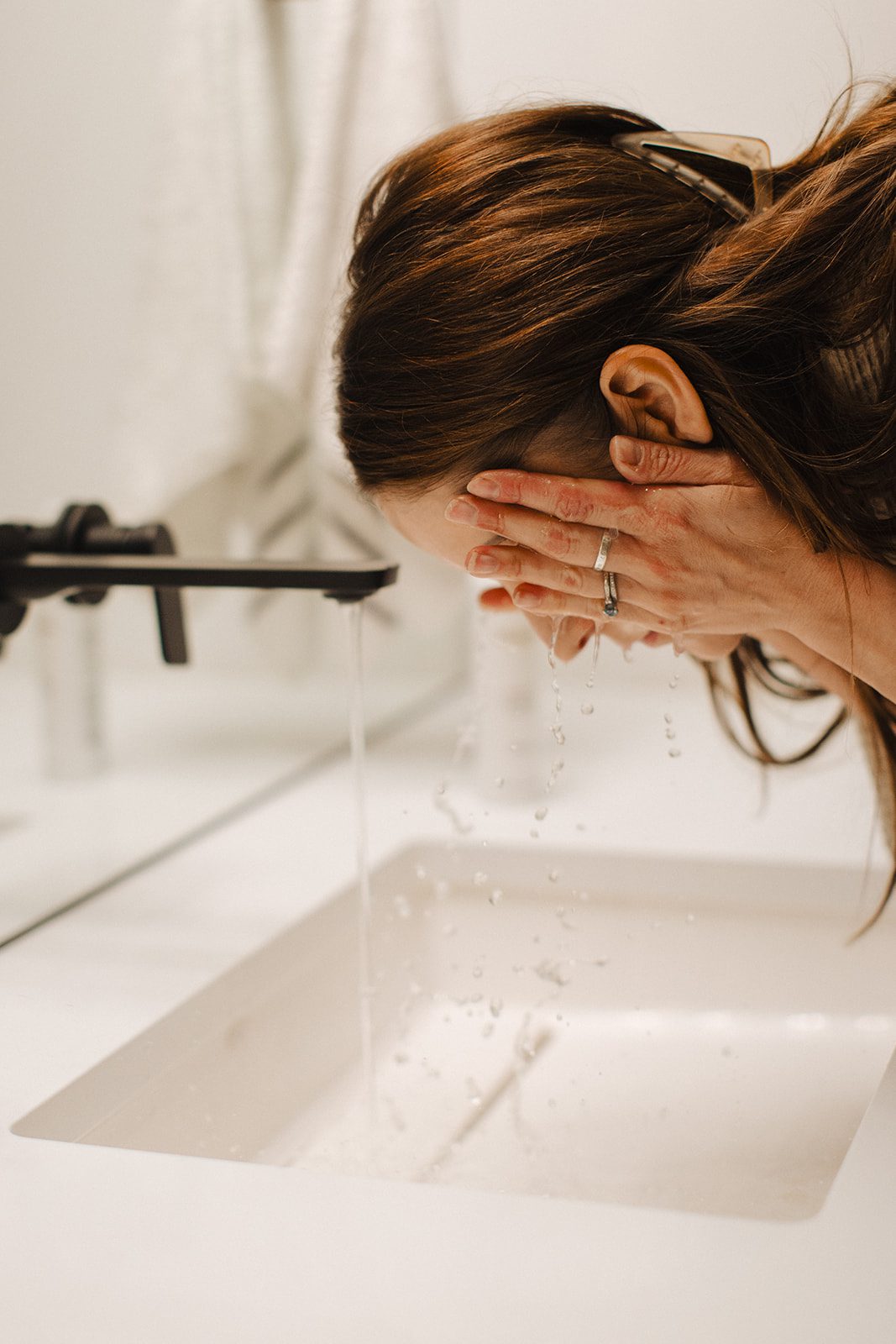 Person washes face at skin.