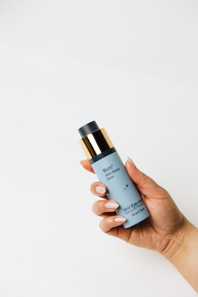 ONYX Beauty Lab | The Onyx Beauty Lab 2025 Holiday Gift Guide Skinbetter Science Mystro Active Balance Serum bottle is held in a hand.