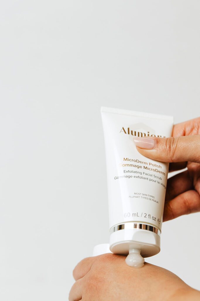 ONYX Beauty Lab | The Onyx Beauty Lab 2025 Holiday Gift Guide A bottle of Alumier Microderm Polish is squeezed to show the product inside.